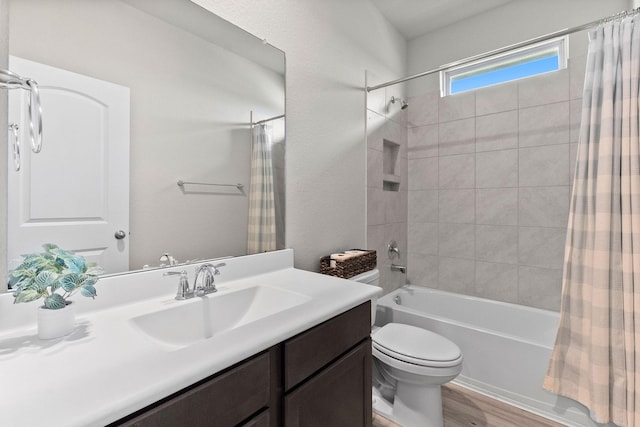 full bathroom featuring hardwood / wood-style floors, vanity, toilet, and shower / bath combo with shower curtain