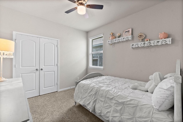 carpeted bedroom featuring ceiling fan and a closet