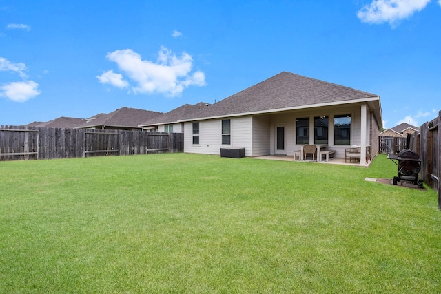 rear view of property featuring a patio and a lawn