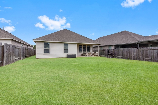 back of house featuring a patio and a yard