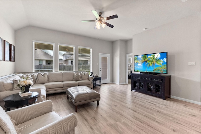 living room with ceiling fan, lofted ceiling, and light hardwood / wood-style floors