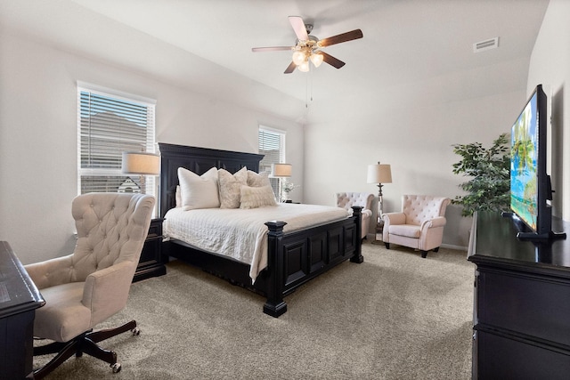 carpeted bedroom featuring multiple windows, lofted ceiling, and ceiling fan