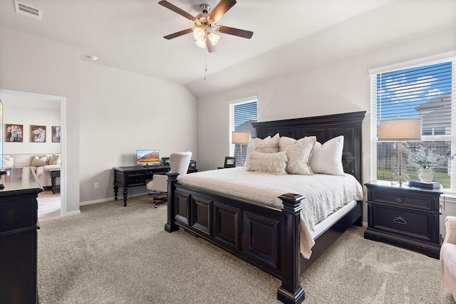 carpeted bedroom featuring ceiling fan and vaulted ceiling