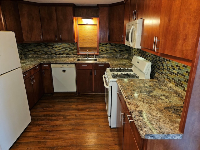 kitchen featuring dark wood-type flooring, sink, tasteful backsplash, stone counters, and white appliances