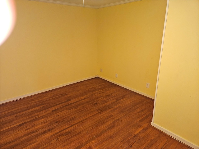 unfurnished room featuring crown molding and dark hardwood / wood-style floors