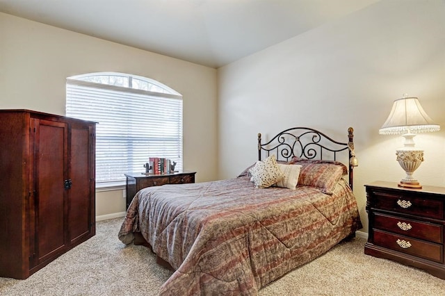 bedroom featuring light carpet