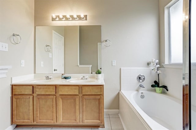 bathroom featuring a bathing tub, tile patterned floors, and vanity