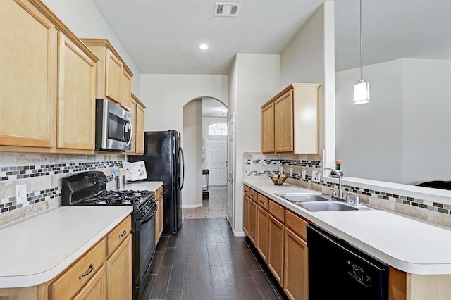 kitchen featuring sink, light brown cabinets, pendant lighting, decorative backsplash, and black appliances