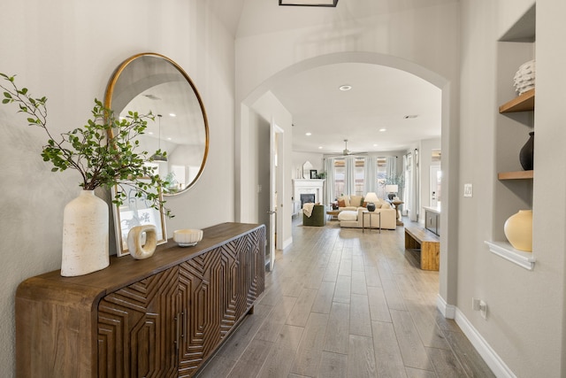 hall with hardwood / wood-style floors and built in shelves