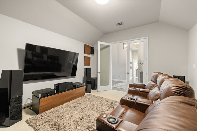 carpeted living room featuring vaulted ceiling and french doors