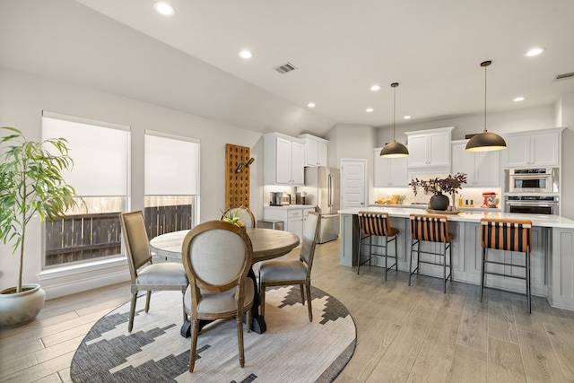 dining space with light hardwood / wood-style floors