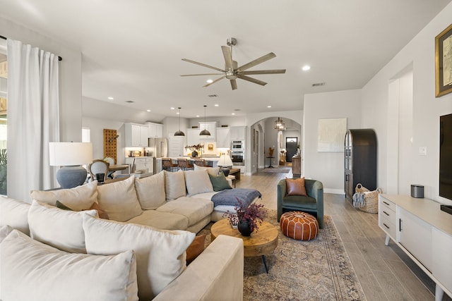 living room with hardwood / wood-style flooring and ceiling fan