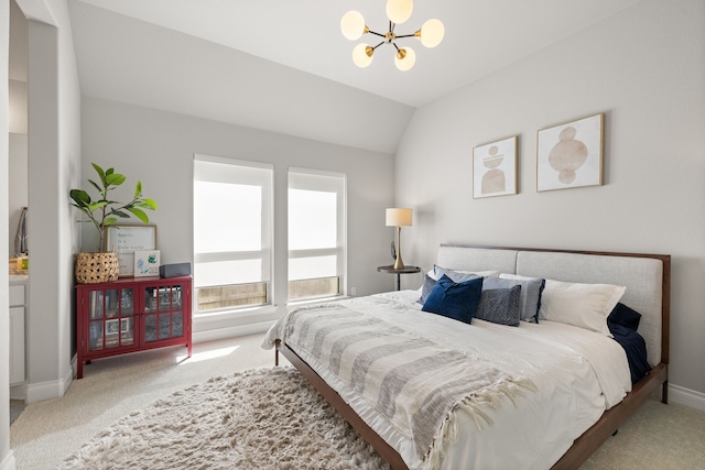 bedroom with lofted ceiling, light colored carpet, and a chandelier