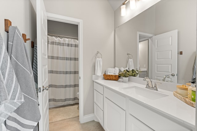 bathroom with vanity, tile patterned floors, and toilet