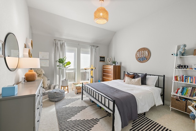 carpeted bedroom with lofted ceiling