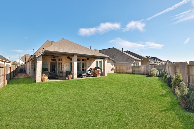 back of house featuring a yard and a patio