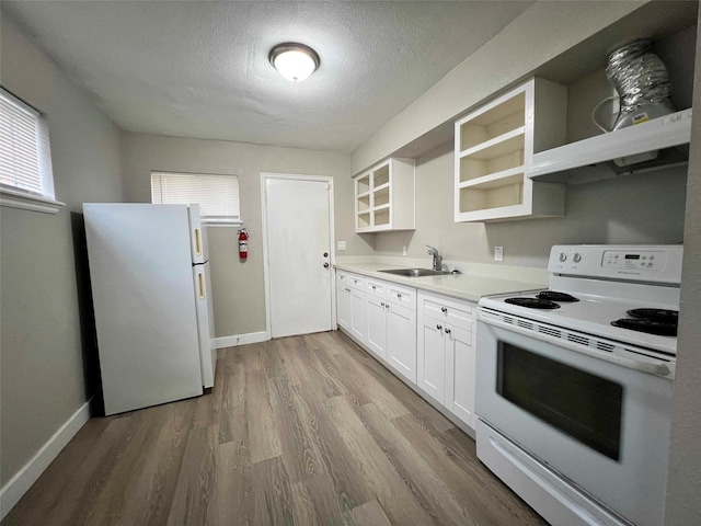 kitchen with sink, white appliances, light hardwood / wood-style flooring, white cabinetry, and a textured ceiling