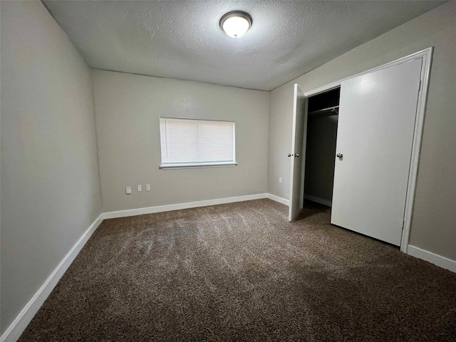 unfurnished bedroom featuring carpet floors, a closet, and a textured ceiling