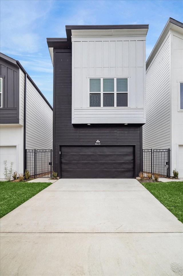 contemporary home with a garage and a front yard