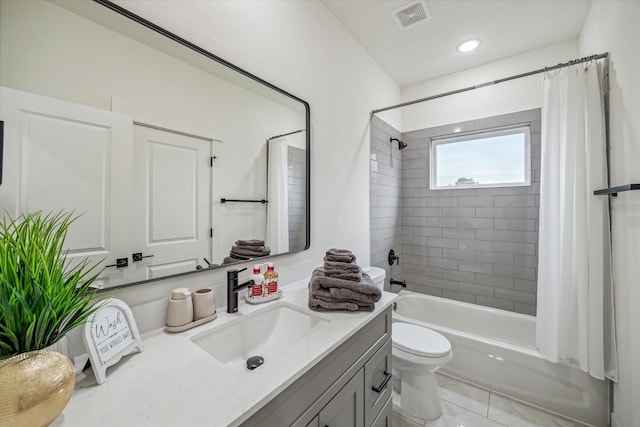 full bathroom featuring vanity, shower / bathtub combination with curtain, tile patterned floors, and toilet