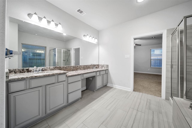 bathroom with vanity and a shower with shower door