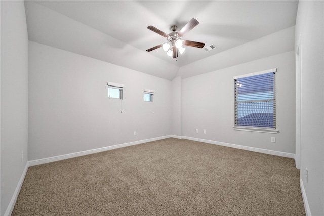 carpeted empty room with ceiling fan and vaulted ceiling