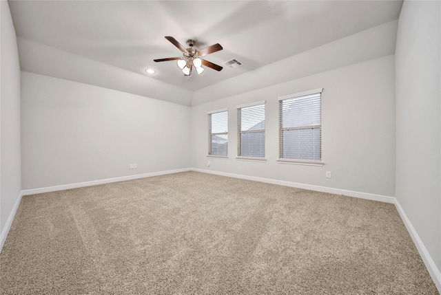 carpeted spare room featuring lofted ceiling and ceiling fan