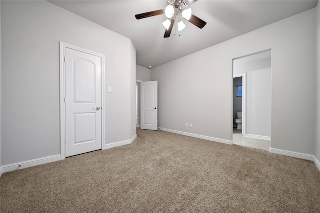 unfurnished bedroom featuring connected bathroom, light carpet, and ceiling fan