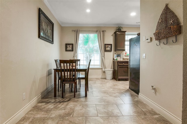 dining space with crown molding