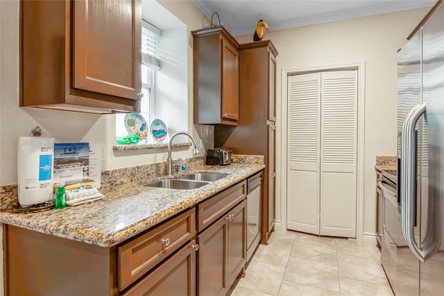 kitchen with sink, crown molding, light tile patterned floors, appliances with stainless steel finishes, and light stone countertops