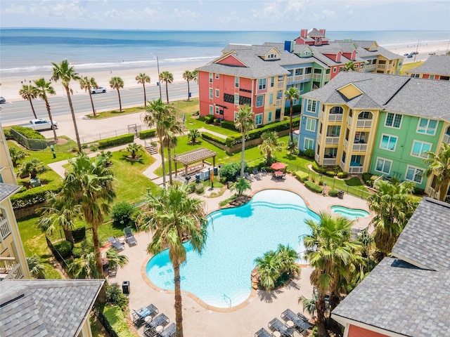 aerial view with a water view and a beach view