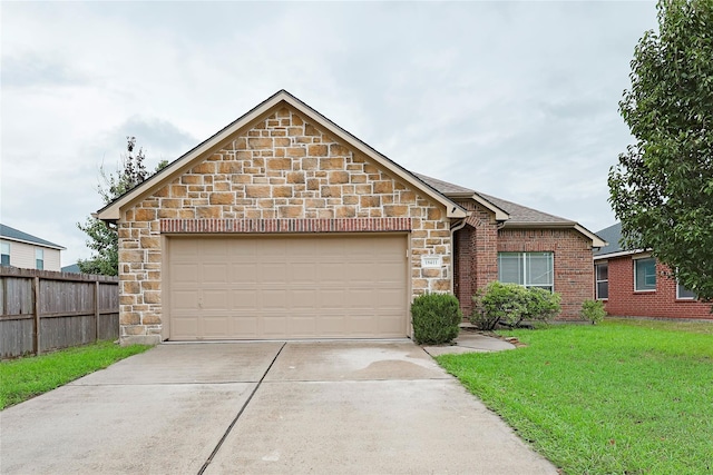 view of front of house featuring a garage and a front lawn