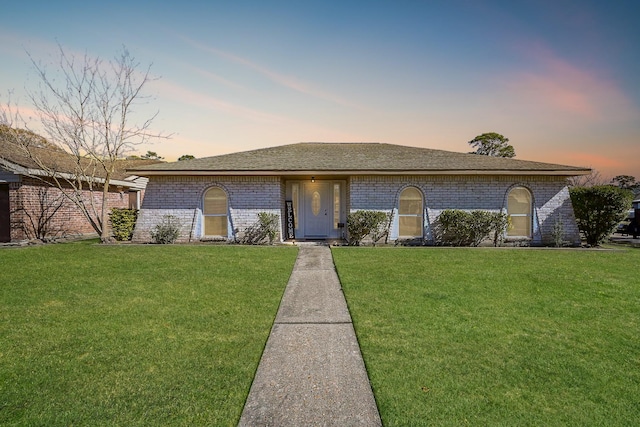 ranch-style house with a yard