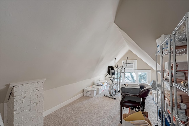 workout area with lofted ceiling, carpet floors, and baseboards