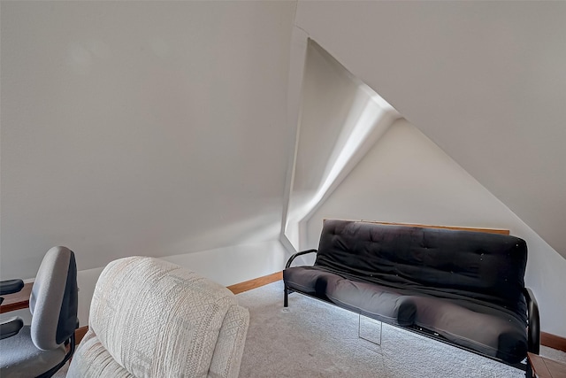 sitting room featuring vaulted ceiling and carpet flooring