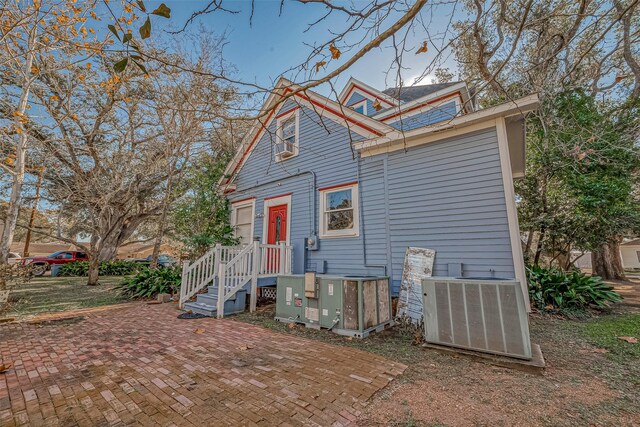 back of property featuring central AC unit and a patio area