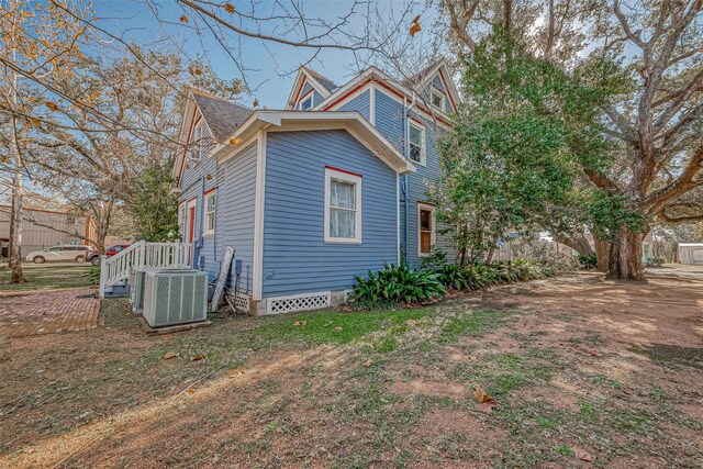 view of side of home featuring cooling unit