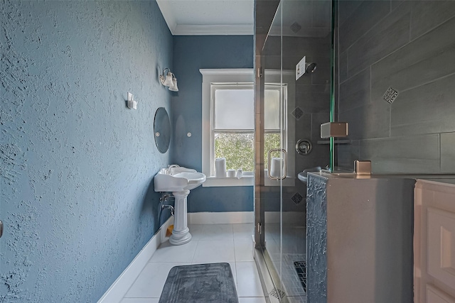 full bathroom with a textured wall, ornamental molding, a shower stall, tile patterned flooring, and baseboards