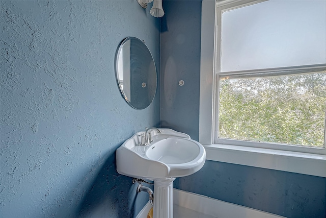 bathroom featuring a textured wall