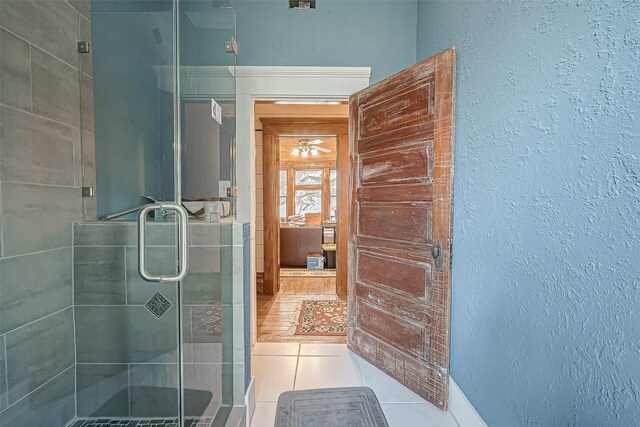 bathroom with tile patterned floors and walk in shower