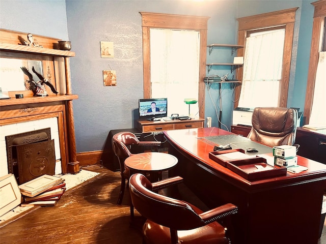 office area with wood finished floors and a textured wall