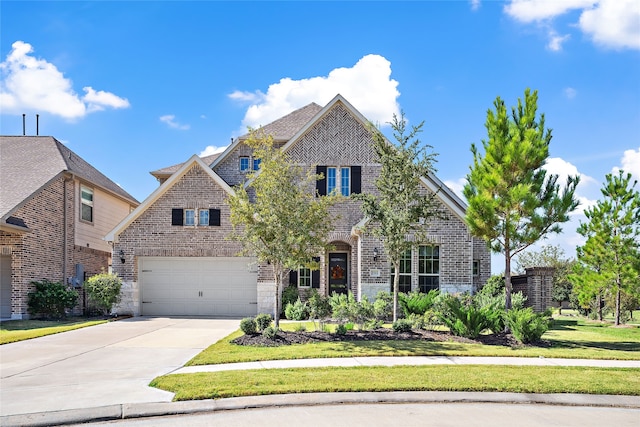 view of front of home featuring a garage and a front yard