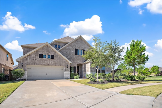 view of front of house with a garage and a front yard