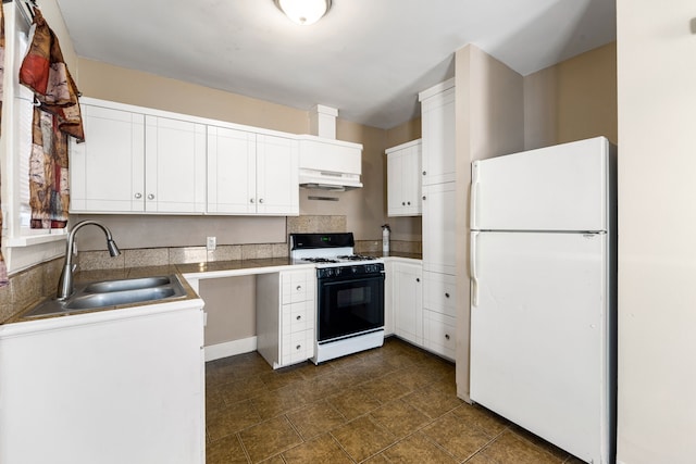 kitchen with white cabinetry, sink, gas range oven, and white fridge