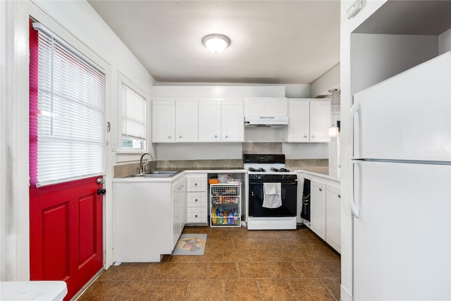 kitchen with range with gas cooktop, sink, white fridge, and white cabinets