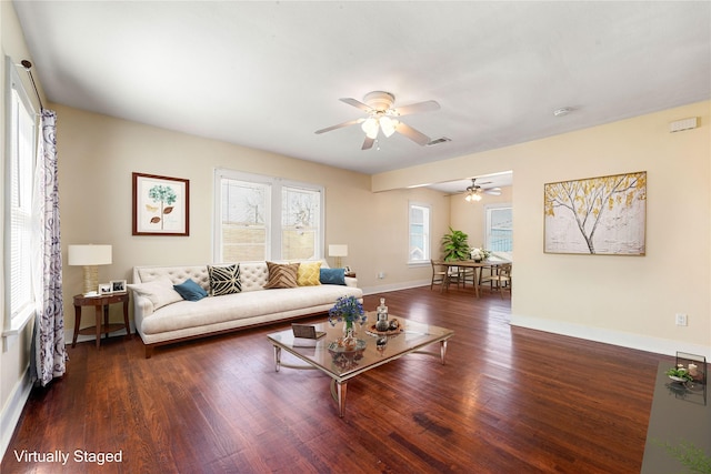 living room with ceiling fan and dark hardwood / wood-style floors