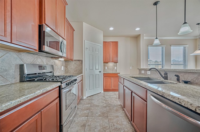 kitchen featuring sink, light stone counters, light tile patterned floors, pendant lighting, and stainless steel appliances