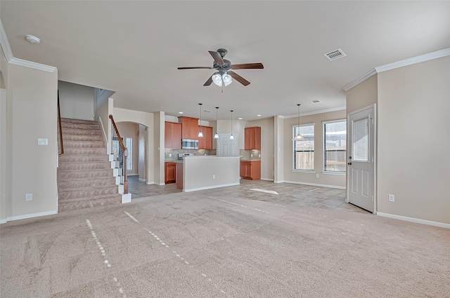 unfurnished living room with light carpet, ornamental molding, and ceiling fan