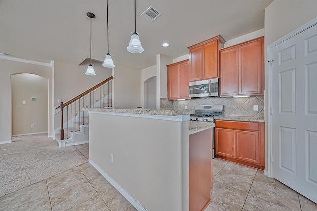 kitchen with tasteful backsplash, appliances with stainless steel finishes, decorative light fixtures, and light tile patterned flooring