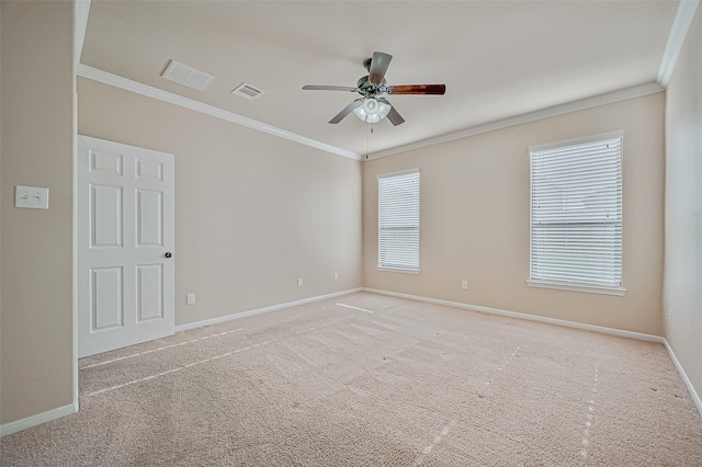 empty room featuring ceiling fan, ornamental molding, and light carpet